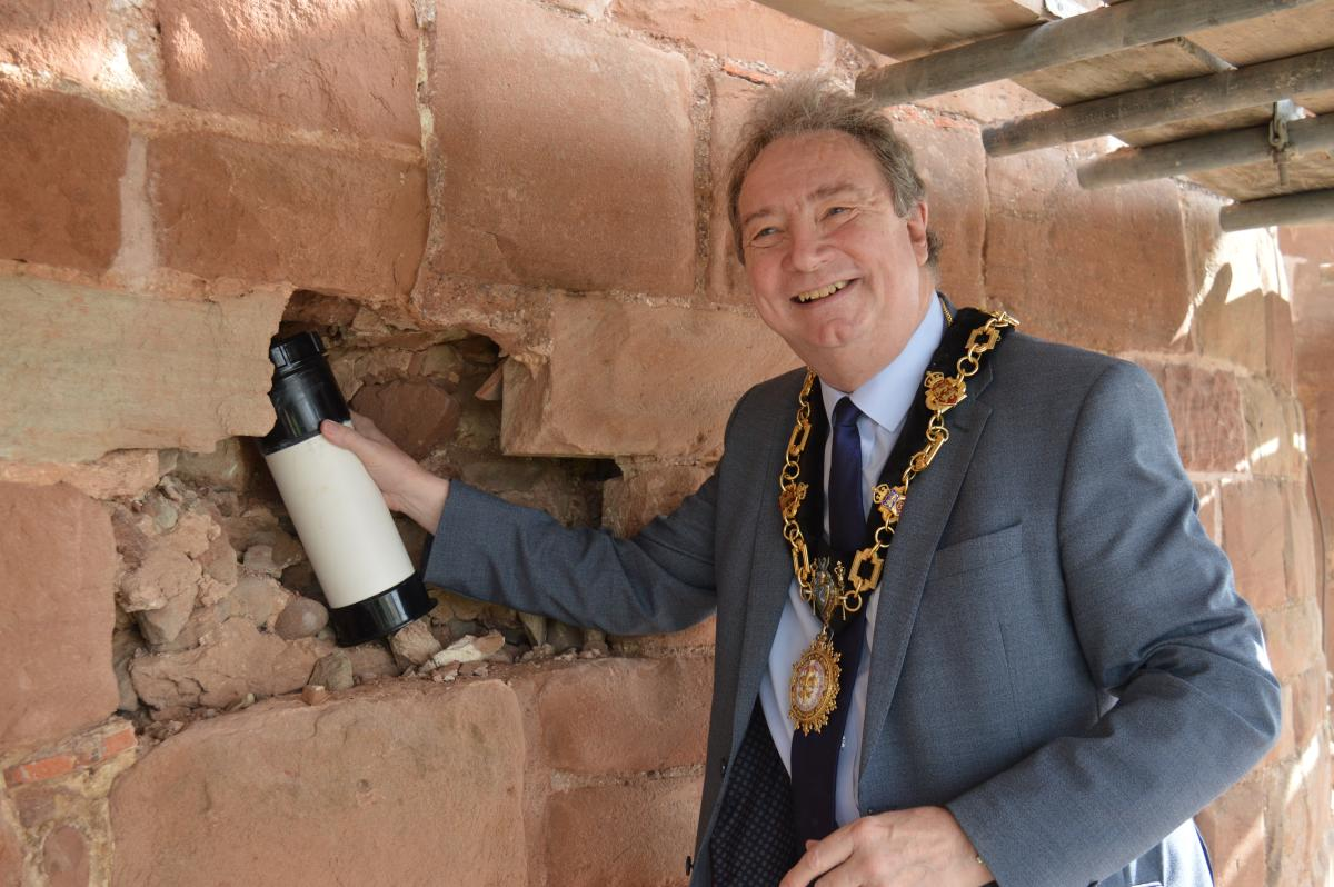 Mayor John Harper with the time capsule in the hole before it gets sealed