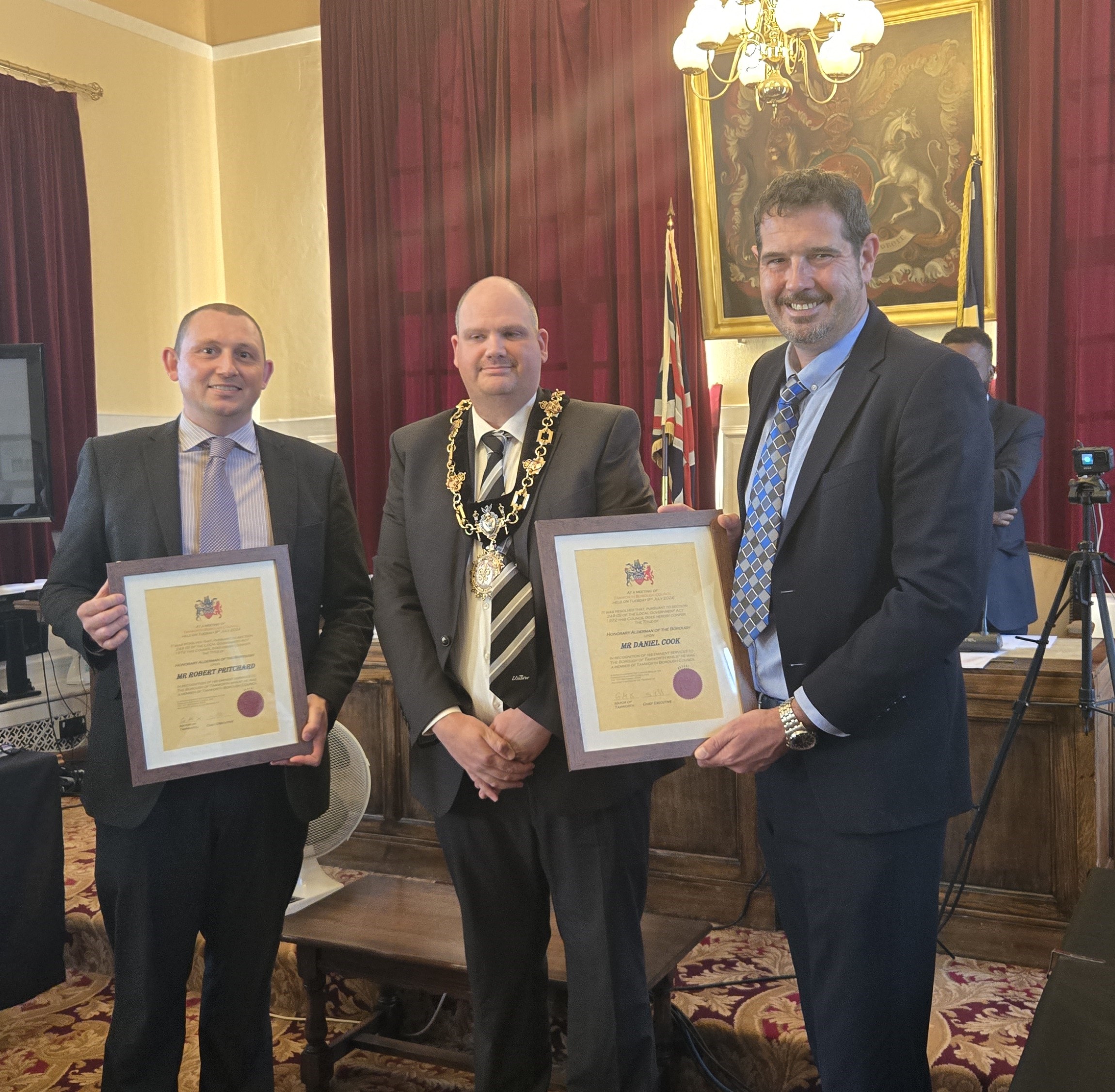 Tamworth's Mayor pictured with Rob Pritchard on the left and Danny Cook on the left holding up their alderman title awards in the town hall.