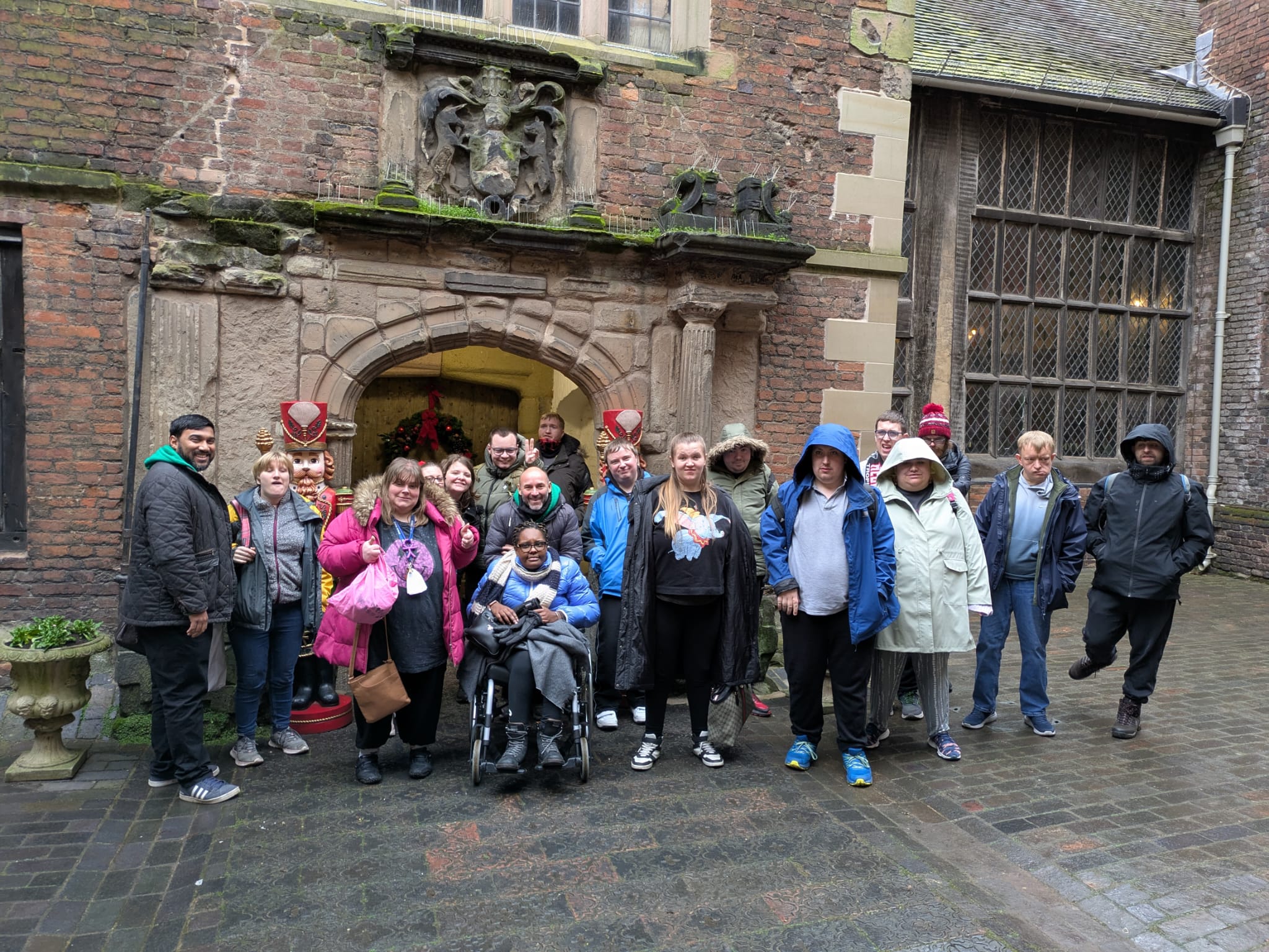 A group of people stood in front of a castle