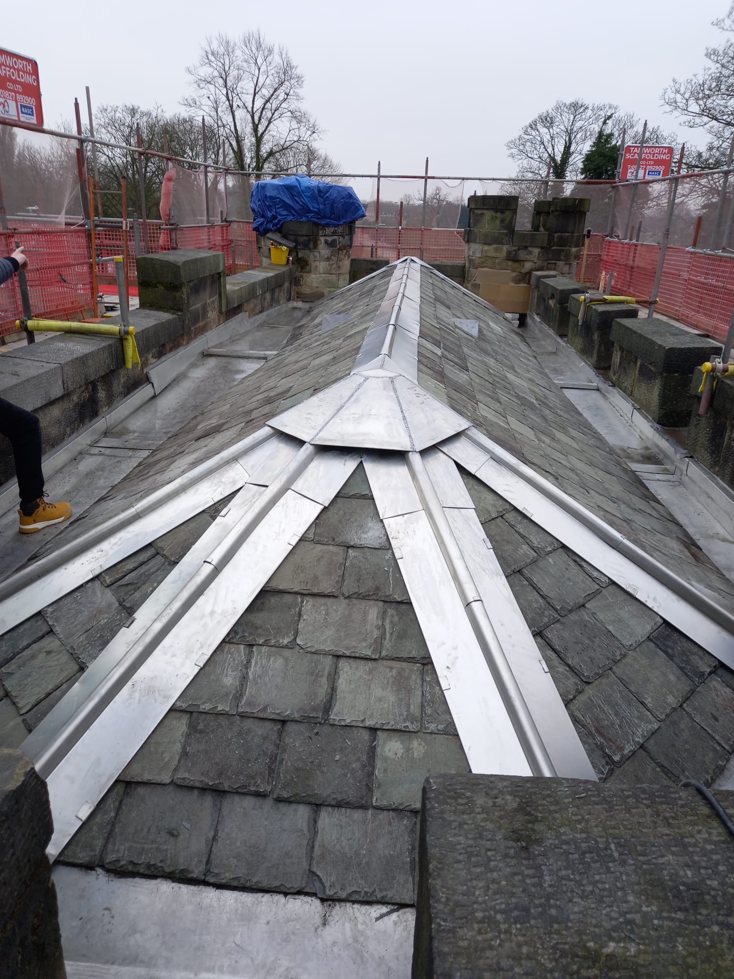 photo of a roof with metal and slate tiles