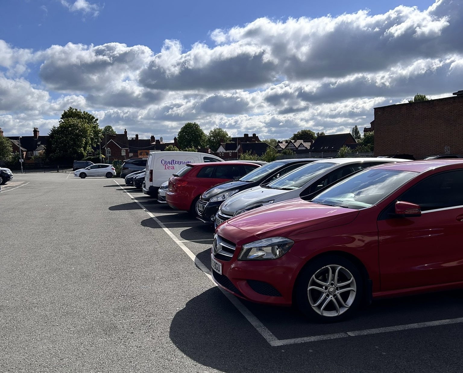 Cars parked in a line in a car park