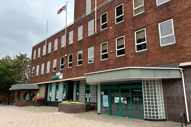 The outside of Marmion House. The council brick building with lots of windows and green doors.