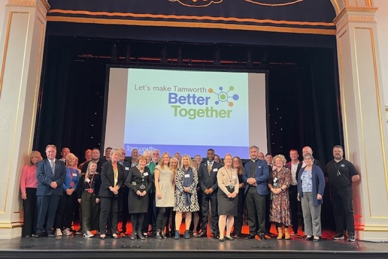 group photo on Assembly Rooms stage of partners from local services