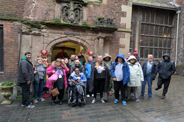 A group of people stood in front of a castle