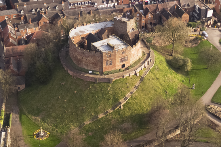 aerial photo of Tamworth Castle and motte with surrounding green grass and Georgian buildings