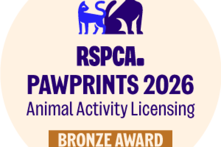 round logo with a blue dog and writing 