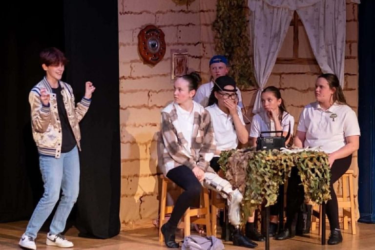 People on a stage acting 