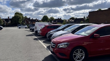 Cars parked in a line in a car park