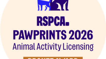 round logo with a blue dog and writing 