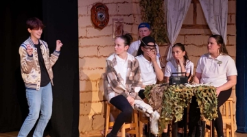 People on a stage acting 